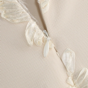 Macro view of invisible zipper and mesh fabric detail on white mermaid dress