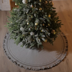 Knitted Christmas tree skirt with fringe edge in light grey and beige boho style