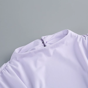 Detail of lavender high-neck knit dress showing fine fabric texture and neckline finish