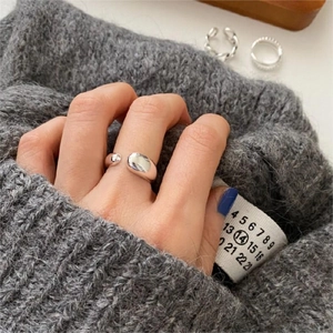 Close-up of minimalist 925 sterling silver water drop ring worn on a finger