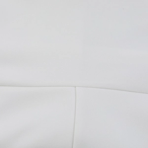Close-up of high-quality sewing stitches on white chiffon mini dress fabric