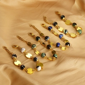 Detail of beaded resin bracelets with gold steel disks and adjustable lobster clasp