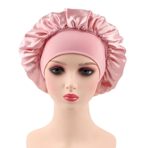 Close-up of pink satin hair bonnet with elastic wide band on a mannequin head