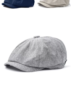 Detailed macro view showing the breathable linen fabric texture of a vintage newsboy cap