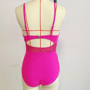 Detail view of pink one-piece swimsuit featuring mesh patchwork and back hook closure