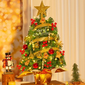 Close-up of a mini Christmas tree with festive ornaments, LED lights, and gold star topper