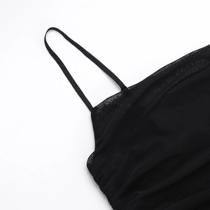 Close-up of thin black shoulder straps and fine mesh texture on a slim-fit summer dress