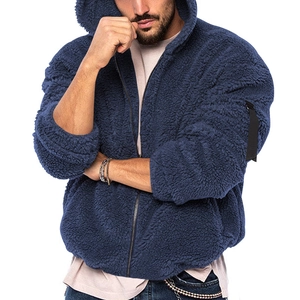 Detailed macro view of dark blue fleece jacket with metal zipper and arm strap