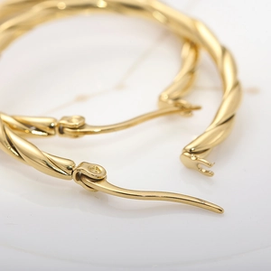 Chic 30mm twisted gold hoop earrings in polished titanium steel for an elegant look