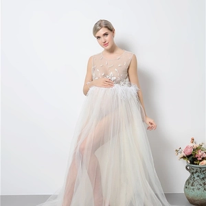 Elegant white maternity dress with sheer mesh, lace embroidery and feather details for photos