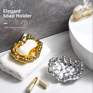 Modern gold and silver wavy soap dish set made of ABS material in luxury bathroom