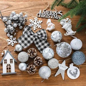 Christmas tree ornament set with silver and white baubles, pine cones and snowflakes