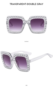 Detail of square sunglasses with transparent gray frame and dense rhinestone embellishment