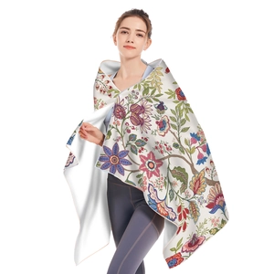Bohemian floral microfiber beach towel with vibrant botanical pattern shown by a model