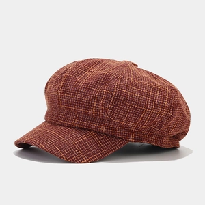 Detailed macro view of the vintage brown tweed texture on a retro newsboy hat for women