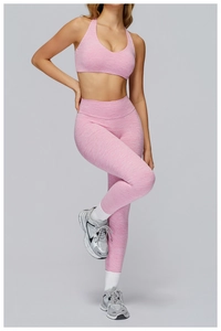 Detail of pink heathered fabric on racerback sports bra and high waisted yoga leggings