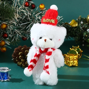 Detailed view of a white plush Christmas bear with red knit hat and LOVE letter ornament