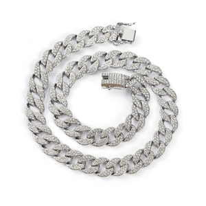 Macro detail of silver-tone cuban chain necklace with sparkling full rhinestone inlay