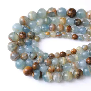 Polished natural blue calcite round loose beads with unique brown mineral textures