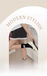 Detail of black ribbed mid-calf sock with elastic cuff and heart letter patch