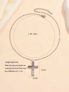 Macro view of a colorful zircon-studded cross pendant with detailed size specifications