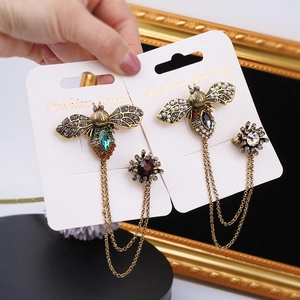Vintage gold bee brooch with green crystals and hanging flower chain decoration