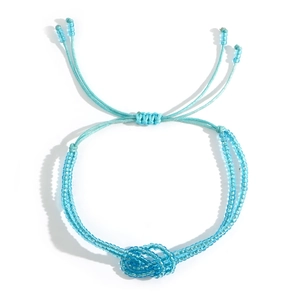 Bohemian blue beaded bracelet with adjustable woven cord closure and glass seed beads