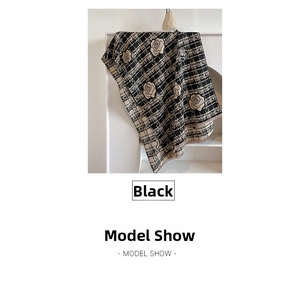 Detail of camellia floral pattern on thick double-sided winter shawl in black and beige