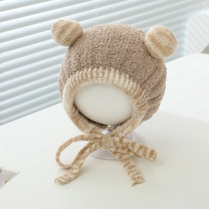 Close-up of baby plush hat showing soft faux shearling texture and bear ear detail