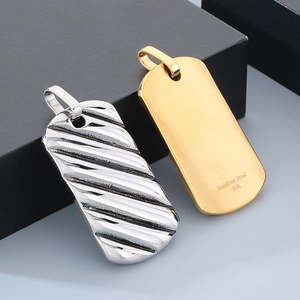 Detail of silver wavy texture and gold smooth 316L stainless steel square pendants