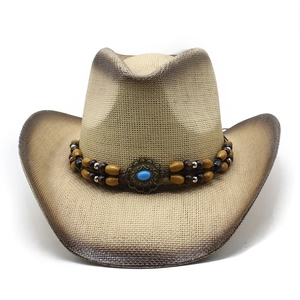 Detailed close-up of straw cowboy hat featuring ethnic beads and blue turquoise stone
