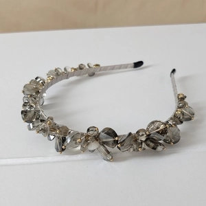 Detail of smoky gray crystal beads hand-wired on a slim metallic headband