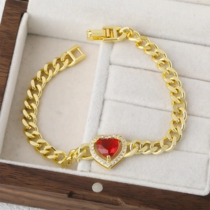 Golden Cuban link bracelet with a red heart gemstone surrounded by white zircons