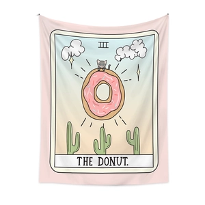 Detail of tarot style tapestry featuring a cute cat on a pink donut with star patterns