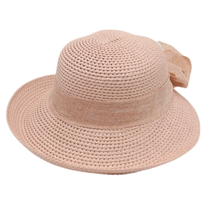 Detailed close-up of woven straw hat texture with an elegant light pink ribbon bow