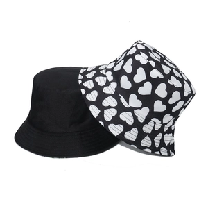 Set of two cotton bucket hats: one solid black and one with white heart patterns
