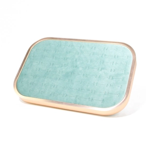 Detail of mint green velvet jewelry tray with rose gold frame and horizontal ring slots