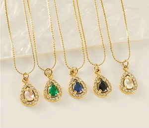 Detail showing five gold necklaces with colorful teardrop-shaped zircon pendants