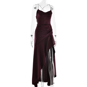 Detail view of the elegant burgundy satin dress showing the high slit and draped ruffle hem