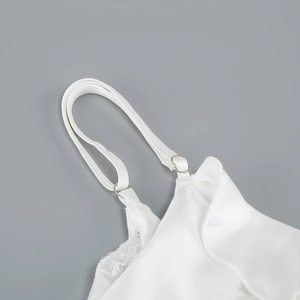 Detail of white satin camisole featuring delicate lace trim and adjustable straps