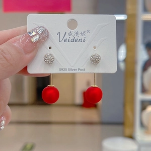 Detail of red globe pendant earrings with crystal stud and S925 sterling silver needle