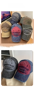 Detail of vintage washed cotton baseball caps with embroidered letters in multiple colors
