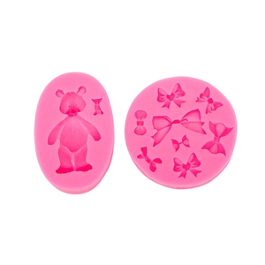 Detail of pink silicone bear and bow molds for DIY cake decorating and baking crafts