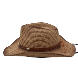 Detail of brown straw cowboy hat featuring silver star rivets on a leather band