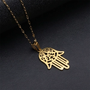 Polished gold Hamsa hand pendant necklace with stainless steel O-chain on black background