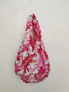 Detailed texture of pink floral stretch tote bag with unique shrink pleated fabric finish