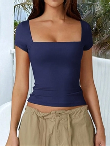 Detail of slim fit dark blue square neck t-shirt worn by model in sunny outdoor setting