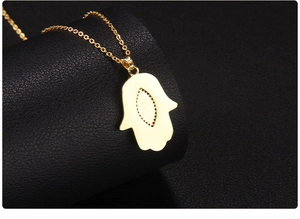 Detailed back view of a gold-plated Hamsa Hand pendant showing the smooth metallic finish