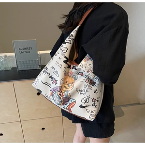 Détail du sac en cuir blanc avec graffitis de dessins animés et bretelles marron