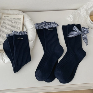 Navy blue lace ribbed socks with gingham bows and ruffles in a lifestyle aesthetic setting